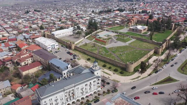 Aerial view of old Georgian town of Telavi overlooking ancient fortified Batonis Tsikhe complex in springtime, Kakheti
