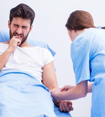 Woman doctor examining male patient in hospital