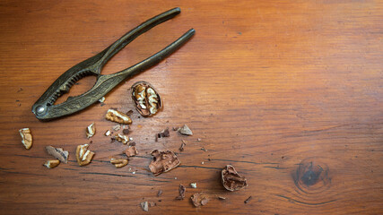 Vintage Nut Cracker with pecan nuts on a wood table