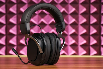 Obraz na płótnie Canvas Professional Modern headphones with a microphone for gamers on a pink background