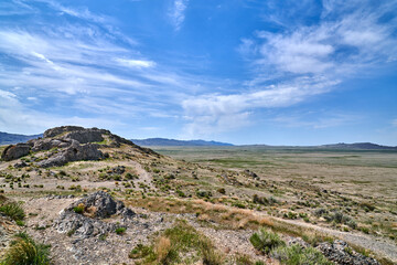 Scenic View of Utah Desert Mountain Rocky Landscape with blue skies and white clouds 
