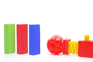 Colorful Domino and Boxing glove fist punch gun on white background. Domino effect concepts for business. Copy space.