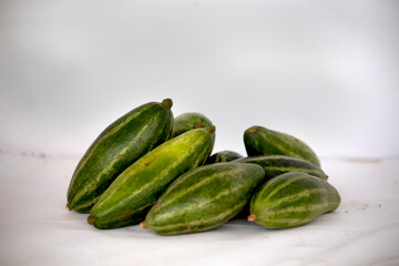 A bunch of Pointed Gourd or parwal and it's behind the white background