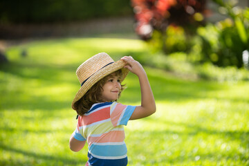 Funny child face. Kids in straw hat, summer portrait.