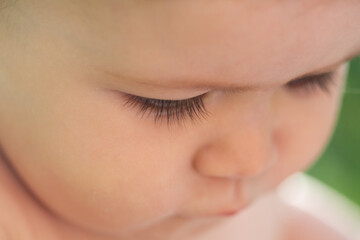 Macro eyelash. Portrait of little baby boy, cropped face with long lashes. Concept of kids face close-up. Head shoot children portrait.
