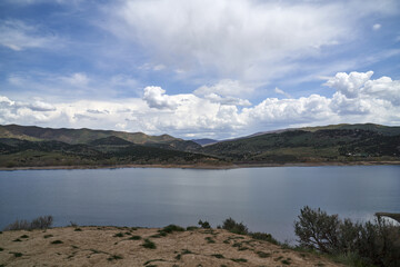 Scenic View of California Lake in the Mountains in summer with blue skies and puffy white clouds