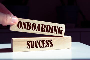Onboarding success symbol. Wooden blocks with words 'Onboarding success'. Beautiful canvas...