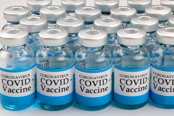 Glass vials labelled with COVID-19 text on white background.