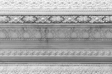 White cement wall carved with Thai temple patterns texture and background seamless