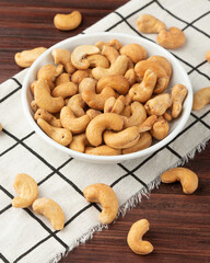 Cashew nuts in white bowl on the table, Healthy snack, Vegetarian food.