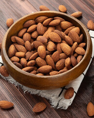 Almonds in wooden bowl on the table, Healthy snack, Vegetarian food.