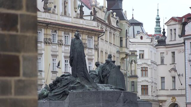 Pigeons flying around Jan Hus statue at Old Town square,Prague,Czechia.