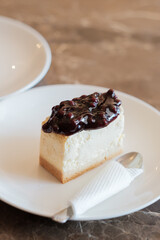 A slice of delicious blueberry cheese cake. Piece of Cake on a Plate. Sweet food. Sweet dessert. Close up.