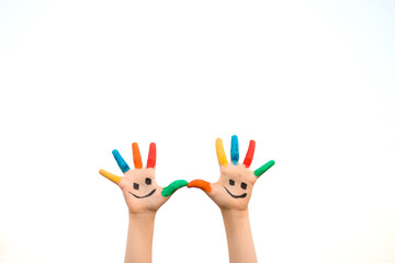 Banner view of children hands in colorful paint with funny smile face isolated on white background