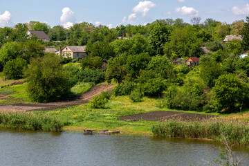 Panorama with a rural landscape. Sura river and Novonikolaevka village in Ukraine