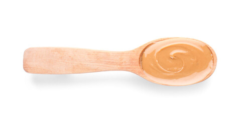 Spoon with tasty peanut butter on white background