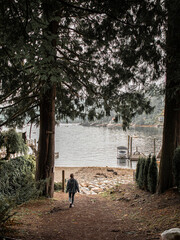 Woman Walking Exploring Through Woods Forest on Rainy Day in Deep Cove British Columbia Canada