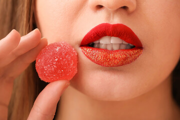 Beautiful young woman with sweet candy, closeup