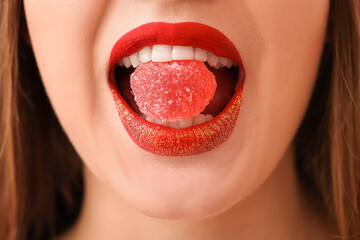 Beautiful young woman with sweet candy, closeup
