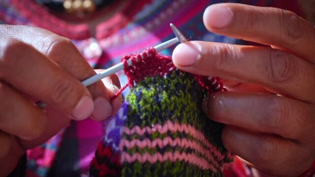 An Ethnic Woman Knitting Handmade Colorful Wool Textile. - Close Up Shot