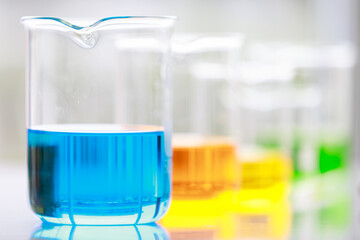 Colorful water and liquid in beager and test tube in laboratory.