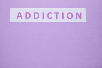 Word ADDICTION on color background