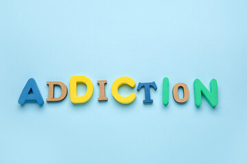 Word ADDICTION on color background