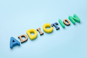 Word ADDICTION on color background