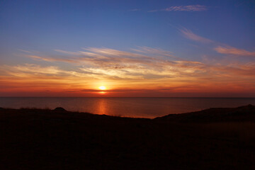 the concept of weather observation, meteorology. wind and small waves. Seascape, mountains and sunset