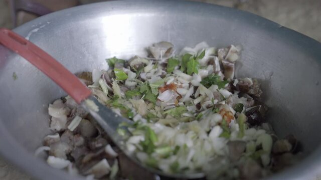 Cilantro and Lomba herbs are added to rural Manipura pig ear chutney