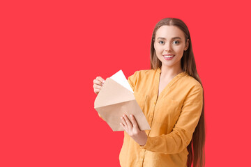 Fototapeta premium Young woman with letter on color background