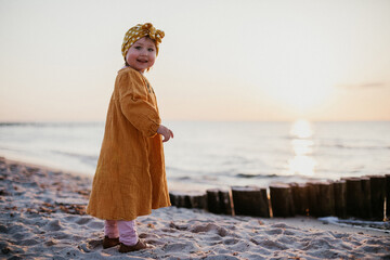 Beautiful smiling child on sunset beach