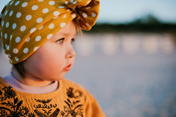 Close-up portrait of beautiful child on sunset beach