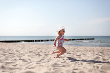 Happy smiling little girl on beach vacation