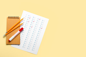 Answer sheet and stationery on color background