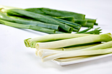 White background, green onions, vegetables.