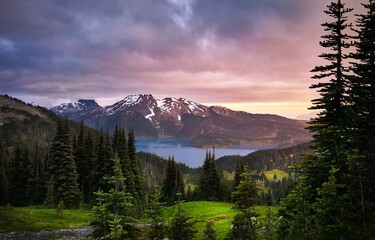 Glacial mountain Garibaldi lake at sunset. View of a mountain lake between fir trees. Mountain...