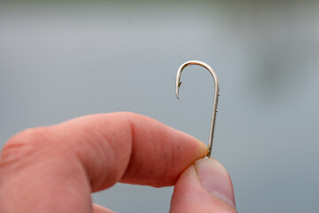 fishing hook in a man's fingers