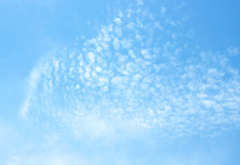 The sky is large, bright, beautiful and has white clouds.