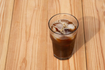 Americano Black Coffee on wooden table in the morning. Iced coffee.