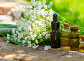 Lily of the valley essential oil in a small bottle. Selective focus.