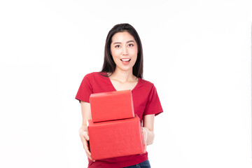 Obraz premium Asian women holding red present box. Portrait of happy smiling Asian girl in casual clothing holding gift box isolated on white. Happy pretty Asian woman holding red gift box on white background.