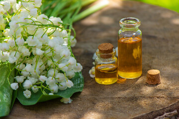 Lily of the valley essential oil in a small bottle. Selective focus.