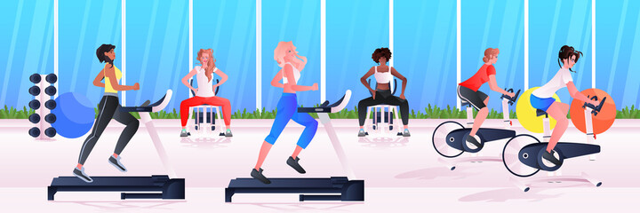 sports women group doing physical exercises mix race girls training in gym aerobic workout healthy lifestyle concept