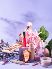 Make up products group with brushes on purple scene background with cube podium - 439241120