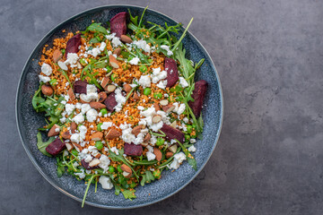 healthy home made couscous salad with sweet potato, beetroot and feta cheese