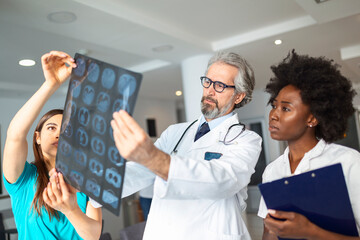 Closeup portrait of intellectual doctors healthcare personnel with white labcoat, looking at lungs...