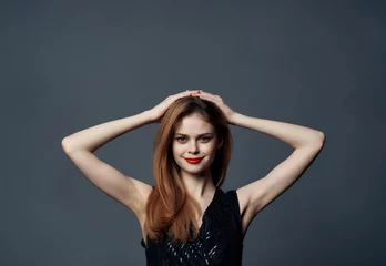 pretty woman in black dress posing on dark background luxury © SHOTPRIME STUDIO