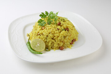 Indian Breakfast Dish Poha Also Know as Pohe or Aalu poha made up of Beaten Rice or Flattened Rice. The rice flakes are lightly fried in oil with mustard, turmeric, onion, curry leaves