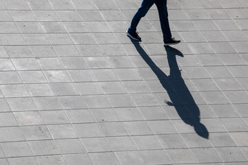 conceptual photography shadow from a guy on a pavement, top view, horizontal.